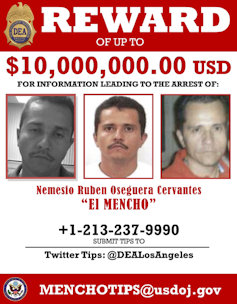 A red and white poster shows a man's face.